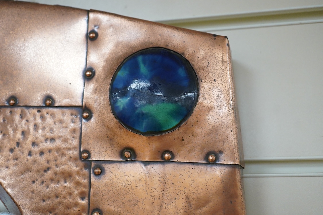 An Arts and Crafts riveted copper and Ruskin pottery cabochon inset mirror, 39cm high